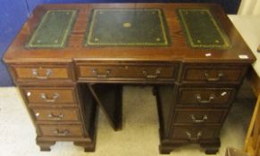 A modern reproduction oak pedestal desk, the top with tooled and gilded leather insert, the