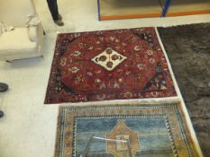 A Persian carpet, the central cream floral decorated medallion on a red floral decorated ground,