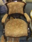 A mahogany framed low salon elbow chair, in brown ground foliate patterned upholstery