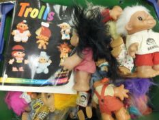 A large selection of troll toys, together with a collector's book