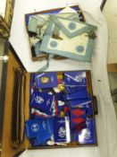 A suitcase containing various Masonic aprons, etc, together with a case containing various Masonic
