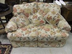 A Christie-Tyler floral upholstered two seater sofa