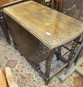A 19th Century oak gate-leg drop-leaf dining table on barley-twist supports, the top with later