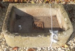 A natural stone sink with cast iron drainer to centre