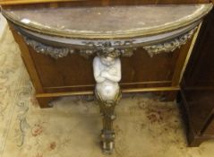 A painted demi-lune hall / pier table with gilded decoration and central cherub support in the Louis