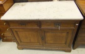 A 19th Century walnut wash stand, the white and grey marble top above two drawers  over two panelled