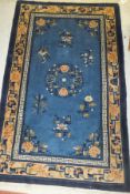 A Chinese rug, the central circular floral medallion on a blue ground within a floral decorated