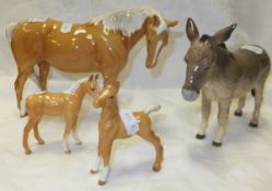 A Beswick pottery figure of a Palomino horse, a Beswick pottery Palomino foal and a Beswick