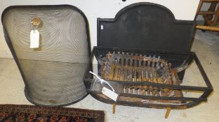 A cast iron fire back, two fire baskets and fire guard