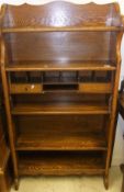 An oak bureau bookcase with various shelves, pigeon holes and drawers
