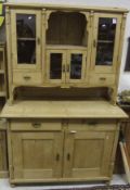 A Continental pine dresser, the top section with various drawers and glazed doors with central shelf