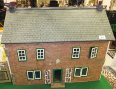 A mid 20th Century doll's house with brick effect front