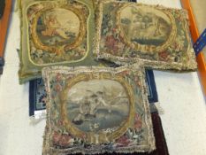 A box containing three velvet cushions, each with an 18th Century needlework / tapestry panel,