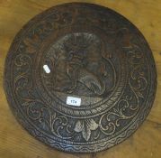 An early to mid 20th Century Far Eastern carved teak table top with central medallion decorated with