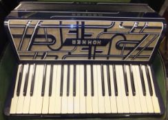 A Hohner Verdi III accordion with blue Art Deco style decoration, housed in a black carrying case