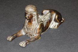 A 19th Century bronze figure of a Sphinx, stamped "41200" to base, 20 cm long x 9 cm high.