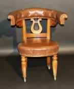 A Victorian oak framed reading chair, the buttoned upholstered curved back rail with scroll carved