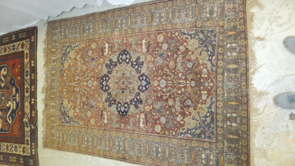 A Persian carpet, the central panel set with a floral decorated medallion on a brown ground with - Image 3 of 10