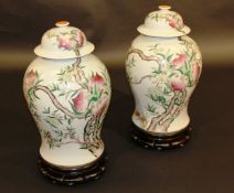 A pair of Chinese "Nine peach" vases and covers, the main bodies of baluster form decorated with