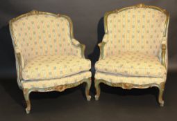 A pair of late 19th Century Continental carved, painted and gilded framed fauteuilles in the Louis