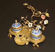 A 19th Century gilt metal desk stand with Chinese blue and white porcelain mounted inkwell and