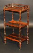 A Victorian rosewood serpentine fronted three tier whatnot with three quarter galleried top on