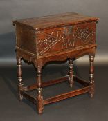 An 18th Century and later oak bible box, the plain top with moulded edge above a carved panelled