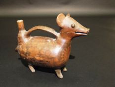 A Peruvian Moche style red clay pottery dog effigy vessel, 29 cm long.