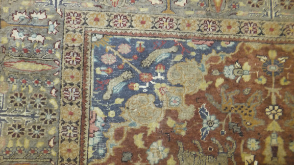 A Persian carpet, the central panel set with a floral decorated medallion on a brown ground with - Image 4 of 10