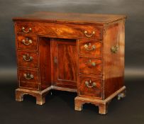 A George III mahogany dressing table, the double rising lid with moulded edge opening to reveal a