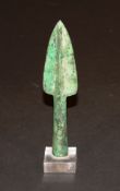 A bronze spear head (Probably Luristan bronze) with verdigris patination, 18.25 cm long, raised on a
