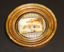 A 19th Century circular marble framed miniature on ivory depicting Dun Robin Castle (stormed in
