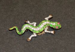 A circa 1880-1920 brooch in the form of a salamander set with demantoid garnets and diamonds, with
