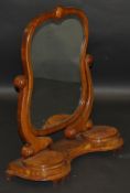 A Victorian walnut framed toilet mirror, the shaped plate on S scroll supports to the shaped
