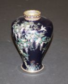 A Meiji-Taisho period Japanese cloisonné vase profusely decorated with birds amongst flowering