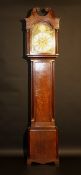 An oak cased longcase clock of typical form, the eight day movement with brass arched dial, the
