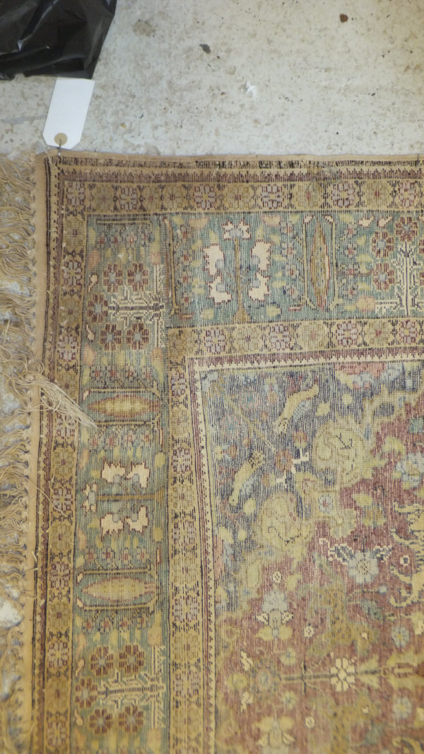 A Persian carpet, the central panel set with a floral decorated medallion on a brown ground with - Image 10 of 10