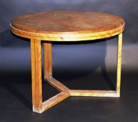 A Continental Art Deco walnut veneered centre table, the circular top cross banded above a