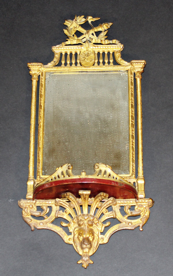 A 19th Century Continental gilt metal girandole, the rectangular mirror plate with galleried and