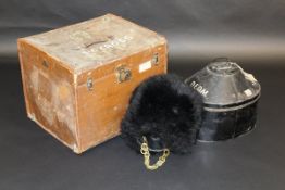 A circa 1900 Guardsman's bearskin, with painted tin hat box and canvas covered and leather trimmed