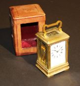 A circa 1900 French lacquered brass cased carriage clock, the white enamelled dial with Roman
