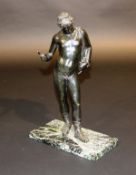 A bronze figure of a classical Roman figure wearing ornate sandals and animal pelt over his left