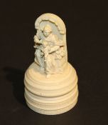 A 19th Century carved ivory figure of Madonna and child raised on a turned and ringed ivory