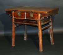 A 19th Century Chinese cherrywood side table, the plain top over two drawers opening to reveal a