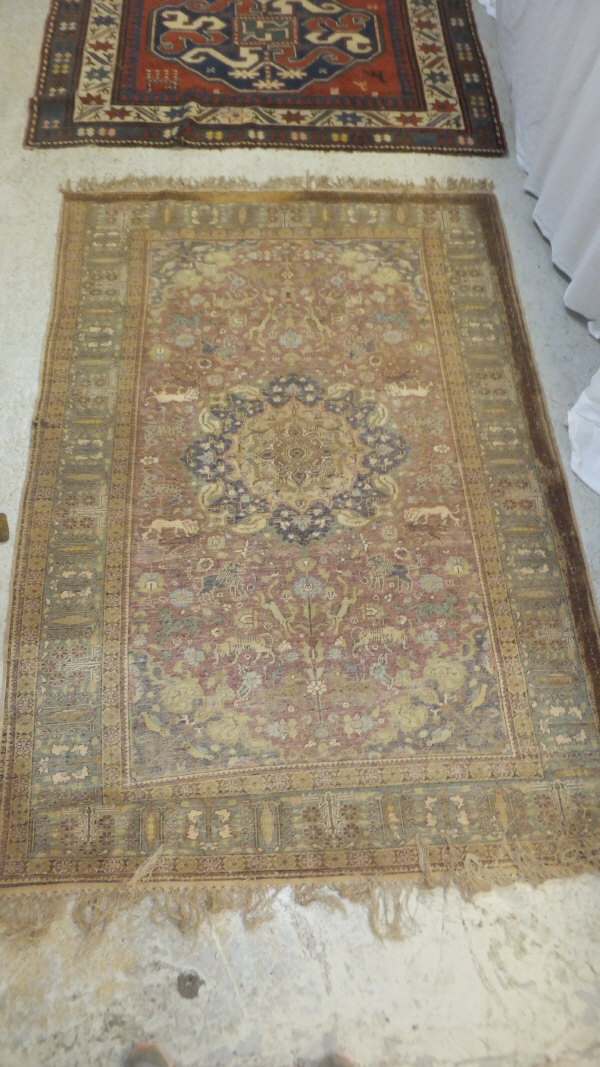 A Persian carpet, the central panel set with a floral decorated medallion on a brown ground with - Image 9 of 10