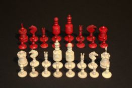 A late 19th/early 20th Century carved bone and stained bone chess set, height of King 9 cm.