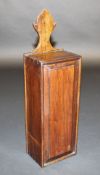 An 18th Century walnut candle box with flower bud shaped hanger over a fielded panelled sliding