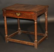An 18th Century and later oak side table, the three plank top over a single frieze drawer raised