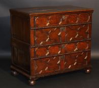 An oak chest in the mid 17th Century manner, the plain top with applied moulded edge above four long