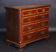An early 19th Century North Country oak and cross banded chest, the top with moulded edge over two